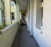 A balcony of a 3-room apartment with outdoor furniture and a view of the courtyard in Bratislava on Janáčkova.