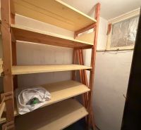Storage room with shelves in a 3-room apartment, easy storage of items.