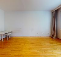 A spacious room with light and a wooden decor floor in a 3-room apartment.