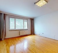 A bright room with curtains and a wooden decor floor, 3-room apartment.