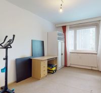 A room with a desk and exercise equipment in a 3-room apartment.
