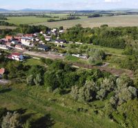 Aerial view of picturesque gardens and landscape in Branč with mountains in the background.