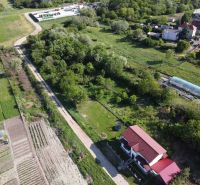 Aerial view of the gardens in Branč with a house and the surrounding landscape.
