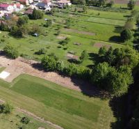 Aerial view of gardens in Hruboňovo with houses and greenery.