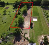 Aerial view of the marked plot with gardens in Hruboňovo, landscaped plots and vegetation.
