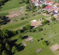 Aerial view of green and cultivated gardens in Hruboňovo near family houses.