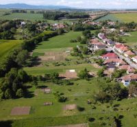 Aerial view of the gardens in Hruboňovo with village buildings and surrounding nature.