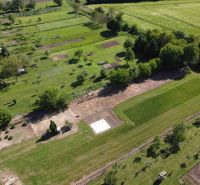 Aerial view of green gardens in Hruboňovo with trees and lawns.