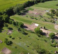 An aerial view of green gardens around Hruboňovo with various plots and trees.