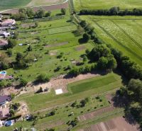 Aerial view of gardens in Hruboňovo, surrounded by fields and rural landscape.