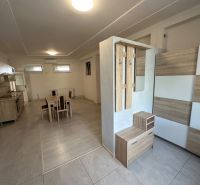 Bright kitchen area and dining nook with a table in a 3-room apartment.