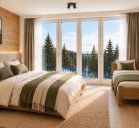 Bright interior of a holiday apartment with wood-decor flooring and a view of nature.