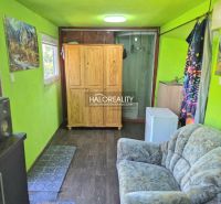 Interior in Gardens with a sofa, wardrobe, washing machine, and wooden decor flooring.
