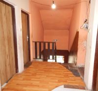 A floor with a wooden decor and stairs in a family house.