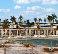 Palm trees and loungers by the beach in Nungwi, in front of the resort with palm trees.