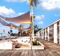 In Nungwi, you will see a beach terrace with seating, palm trees, and a wooden decor floor.