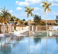A pool with loungers and palm trees in Nungwi creates a relaxing seaside atmosphere.