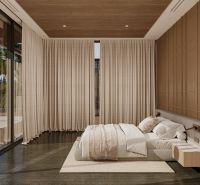 Bedroom in a villa with large windows, wooden decor flooring, and a palm view.