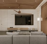 Living room of the villa with a sofa, television, and wooden decor flooring.