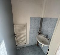 Bathroom with a sink and central heating in commercial premises.