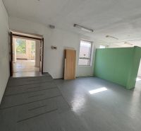 Interior of commercial spaces with windows, entrance, and simple flooring with wooden decor.