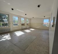 Spacious commercial spaces with tiling and large windows for natural lighting.