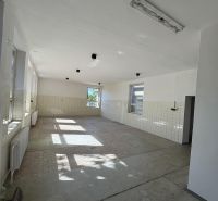 Bright interior of commercial spaces with large windows and ceramic tiles.