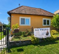 A family house for sale in Demandice surrounded by a garden and fencing.