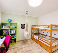 A children's room in a 3-room apartment with a hanging chair and a bunk bed.
