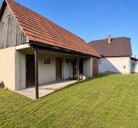 A family house in Sebechleby with a courtyard and a shelter, surrounded by a landscaped grassy area.