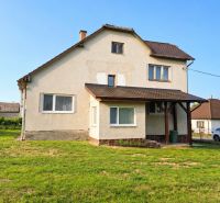 A family house in Sebechleby with a simple facade and a spacious lawn.