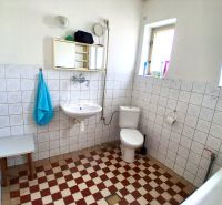 Bathroom in a family house with tiles and classic equipment.