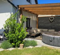 A terrace with a seating set and a hot tub at a 3-room apartment on Banská Street in Banská Bystrica.
