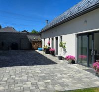 Spacious yard with concrete paving, grill, and flowers at a 3-room apartment on Banská Street.
