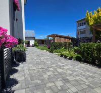 Floral decoration and a paved walkway in the garden of a 3-room apartment on Banská Street in Banská Bystrica.