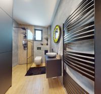 A bathroom in a 3-room apartment with a wooden decor floor and modern design.