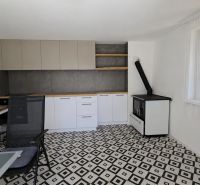 A kitchen in a 3-room apartment with tiles and geometric flooring.