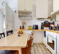 A bright kitchen in a 3-room apartment with a wooden table and tiled floor.