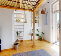 Attic room with staircase and wooden decor flooring in a 3-room apartment.