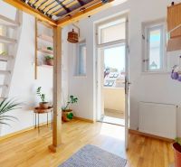 A bright interior in a 3-room apartment with plants and a wooden decor floor.