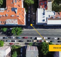 An aerial view of Jiskrova Street shows a parking lot and rooftops of buildings.