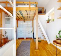 Interior of a 3-room apartment with a wooden decorative floor and a practical sleeping gallery.