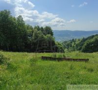 Gardens in Hriňová with a view of the hills and blue sky.