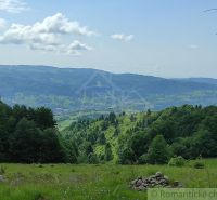 A breathtaking panorama of Hriňová from Záhrady, bordered by forests and hills on the horizon.