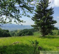 Gardens in Hriňová with a view of green hills and a blue sky.