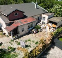 A family house with a neglected yard on a plot in Dunajská Lužná, suitable for living.