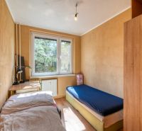 A room with light furniture, a table, and a bed in a 4-room apartment.