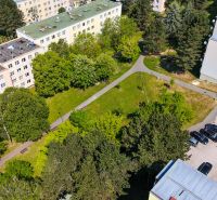 View of Viestova Street with apartment buildings and greenery in Myjava, ideal for a 4-room apartment.