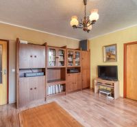 Living room with antique furniture, wooden decor flooring, in a 4-room apartment.