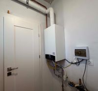Boiler room in a family house with a gas boiler and electrical installation.